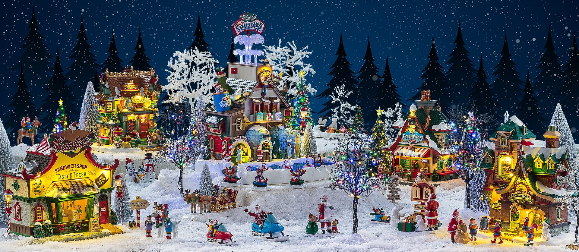Villages Lemax Collection Colorful illuminated Christmas village diorama with snow trees and playful figures set at nightfall under falling snowflakes
